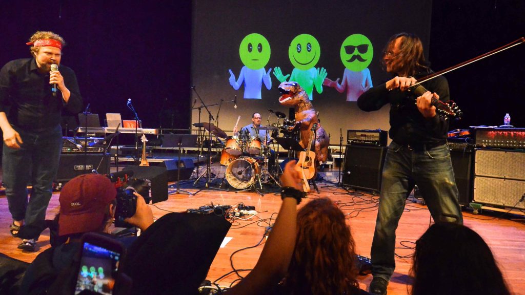 The Chuck and David Show: Chuck Bontrager and David Wallace perform Nirvana's Breed, replete with a thrash-dancing dinosaur